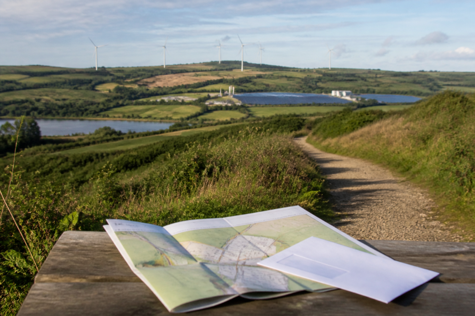 Renewable energy infrastructure viewed from a UK countryside footpath